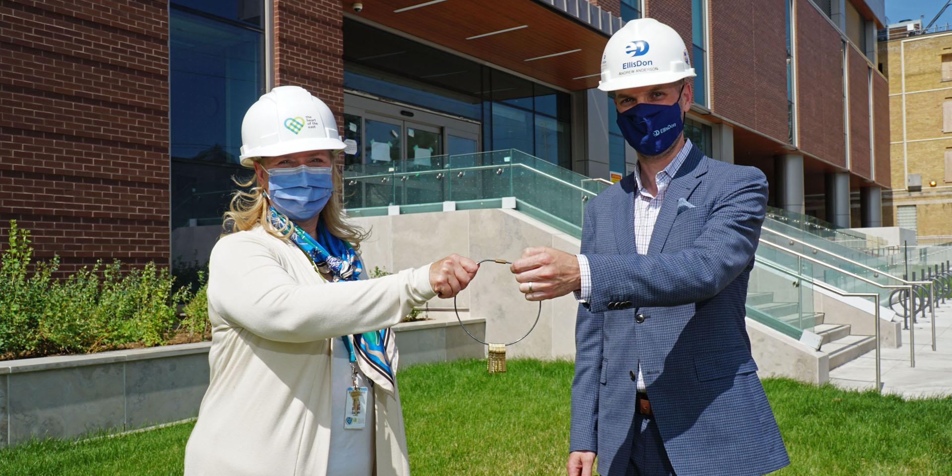  Sarah Downey, President and CEO of MGH receives the ceremonial keys from EllisDon's Andrew Anderson.