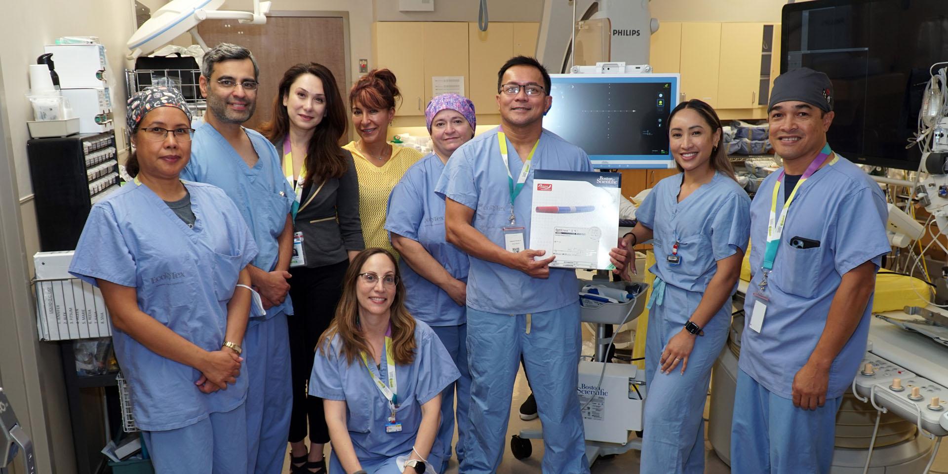 Members of the Cardiac Catheterization Laboratory Team standing together inside a procedure room at Michael Garron Hospital. Members of the Cardiac Catheterization Laboratory Team standing together inside a procedure room at Michael Garron Hospital.