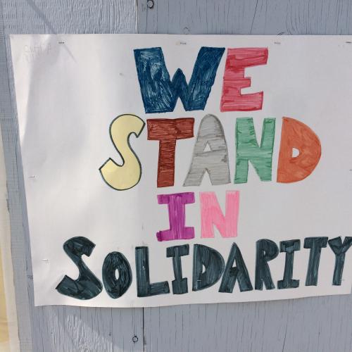 We stand in solidarity sign