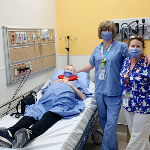 Patient in procedure room with two staff 