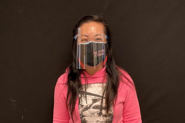 Lisa Tsue, an educator at Grenoble Public School, is photographed wearing a mask and face shield.