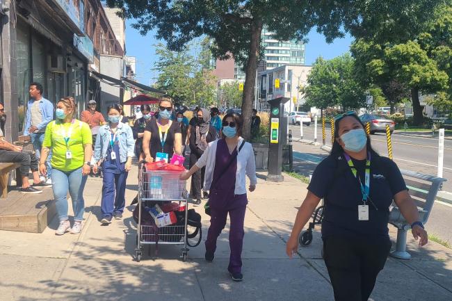 Nurses and clerks from ETHP's mobile vaccination team walk along the streets of East Toronto to administer vaccines to residents.