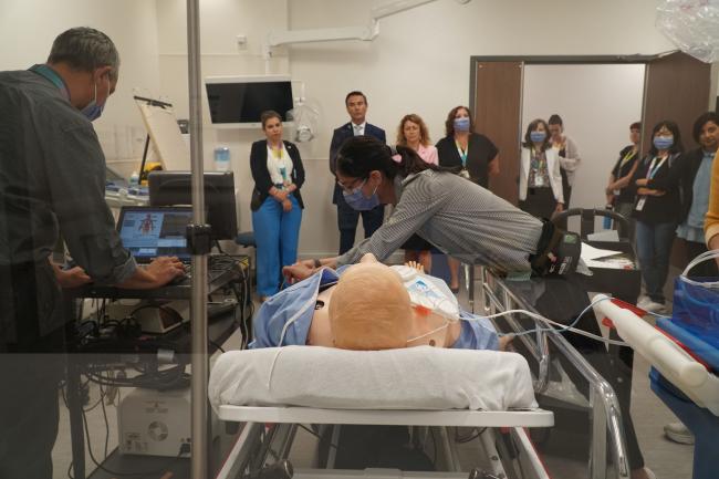 Staff and learners gather in The Rands Family Simulation Centre and participate in a skills lab with a mannequin.