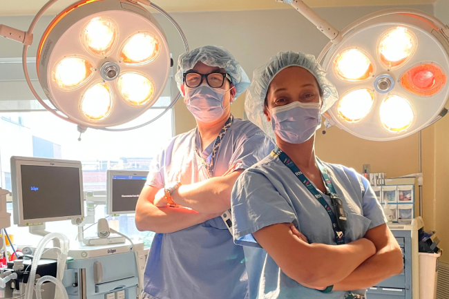 Kevin Ly and Catherine Antoine, perioperative nurses at Michael Garron Hospital. They are standing with their arms crossed in the operating room.