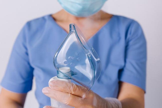 Healthcare worker holds a mask in their hands Healthcare worker holds a mask in their hands
