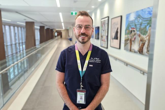 A physician stands in a hospital hallway. A physician stands in a hospital hallway.