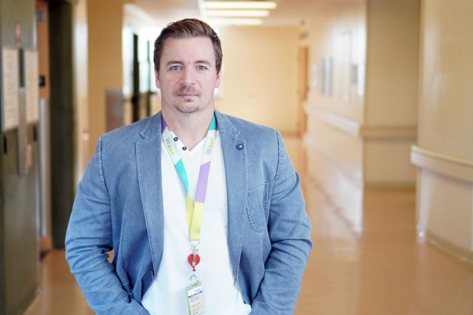 Sean Healey, Social Worker at Michael Garron hospital, standing in hallway