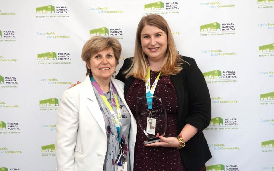 Leah Dunbar, a project manager for the Mobile Crisis Intervention Team, accepted the Build Community award for her first ever poster project. She credits her success to her director Linda Young (left) (Photo by: Ellen Samek)