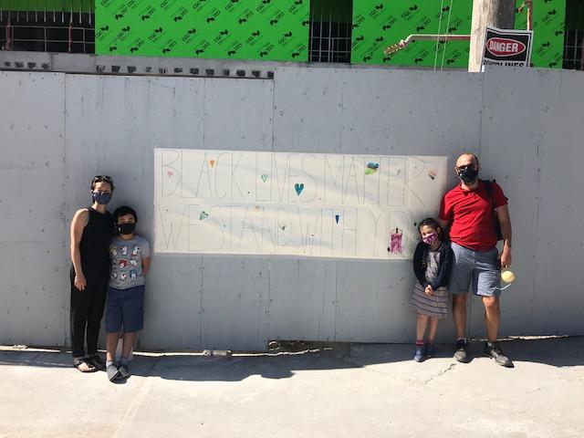 Black Lives Matter Sign Local family stands with homemade Black Lives Matter sign