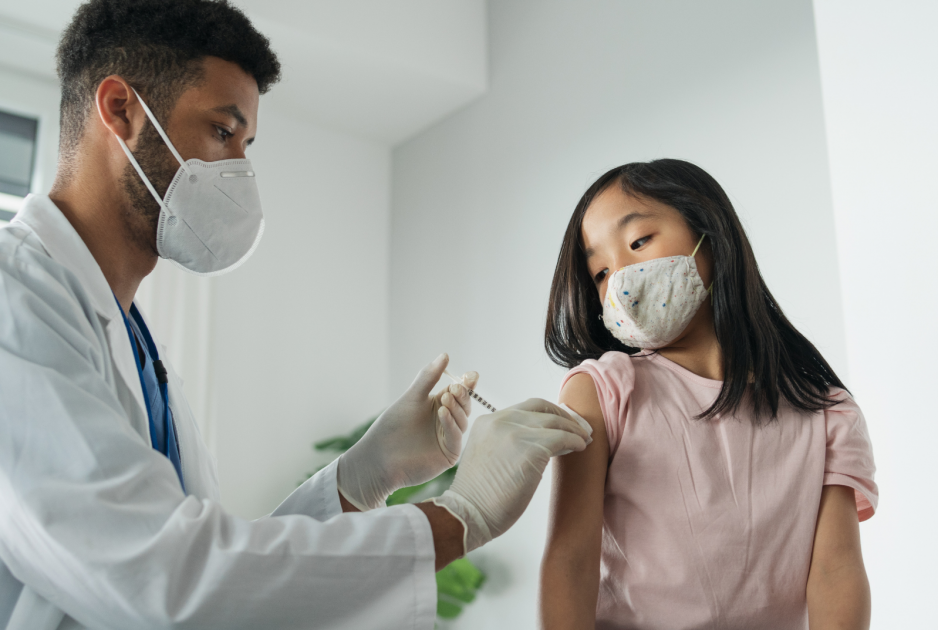 A child is vaccinated by a healthcare worker.