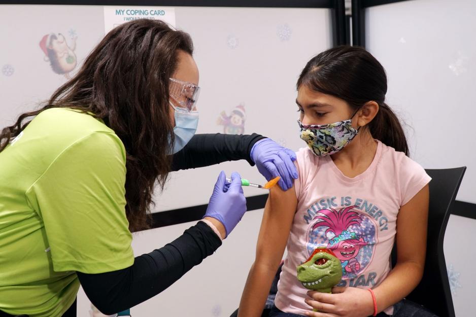A child receives their COVID-19 vaccine. A child receives their COVID-19 vaccine.