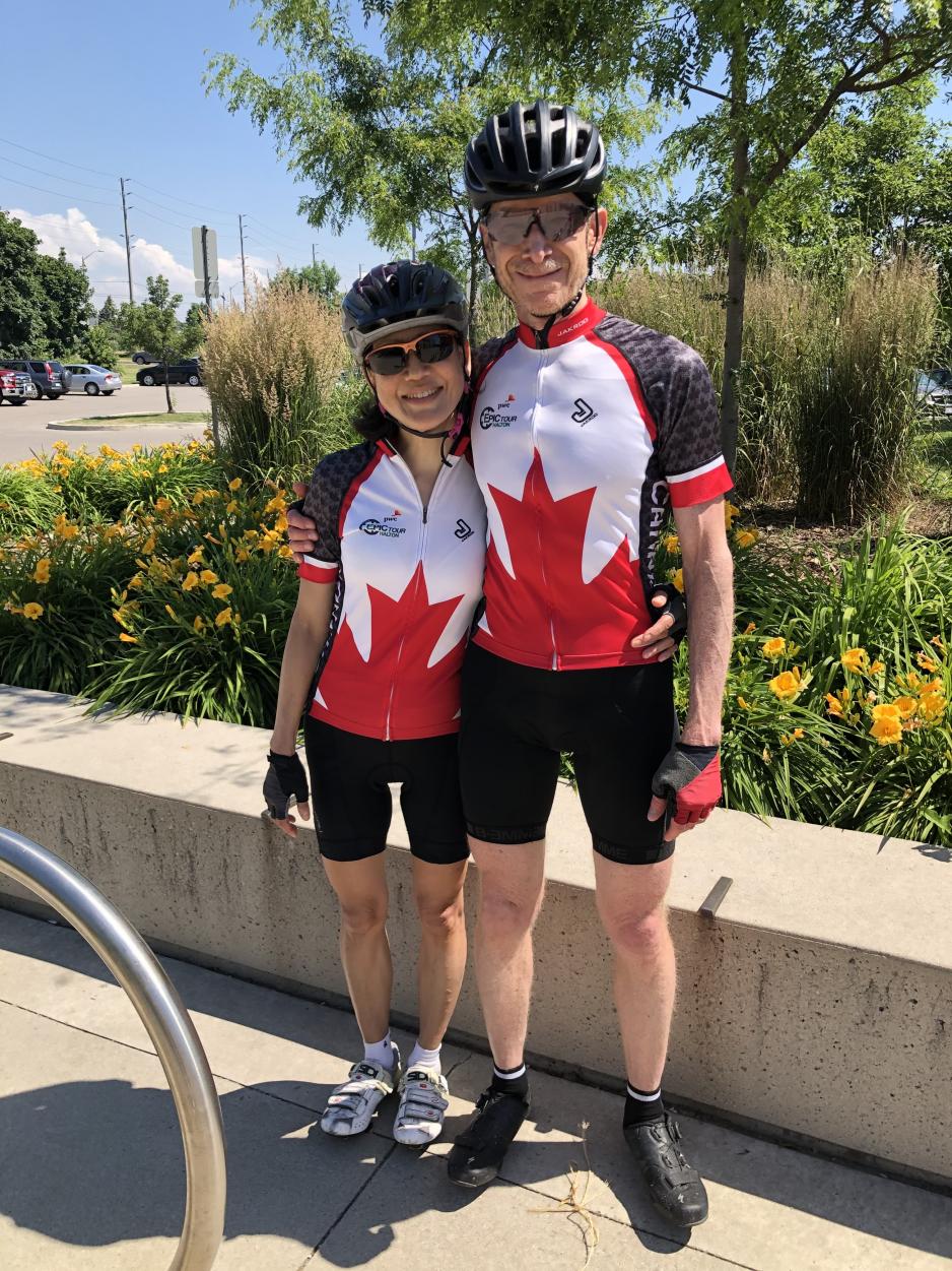 Wolf and his wife, Sandra, wearing bike helmets and cycling gear.