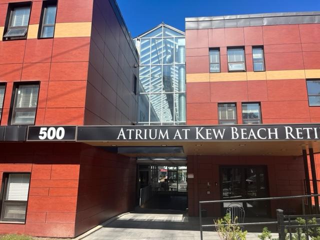 Photo of building with sign reading, "Atrium at Kew Beach"