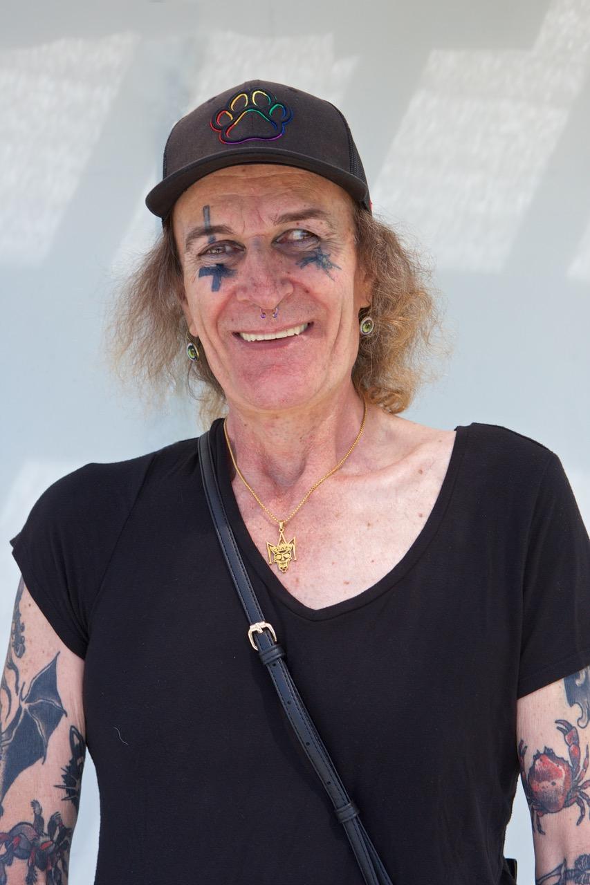 A man smiling and wearing a black T-shirt.