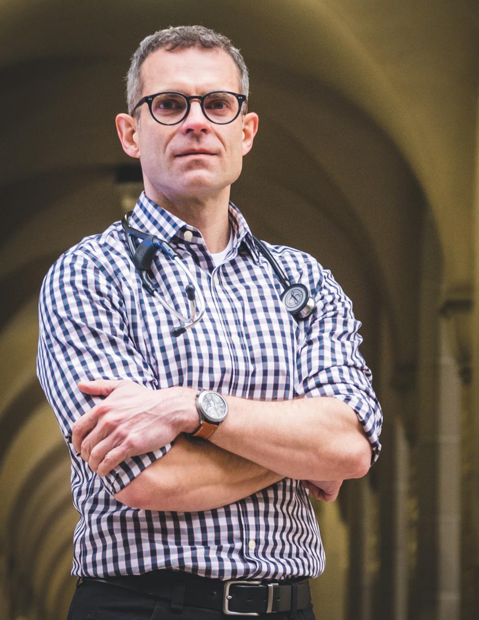 A doctor standing with his arms crossed.