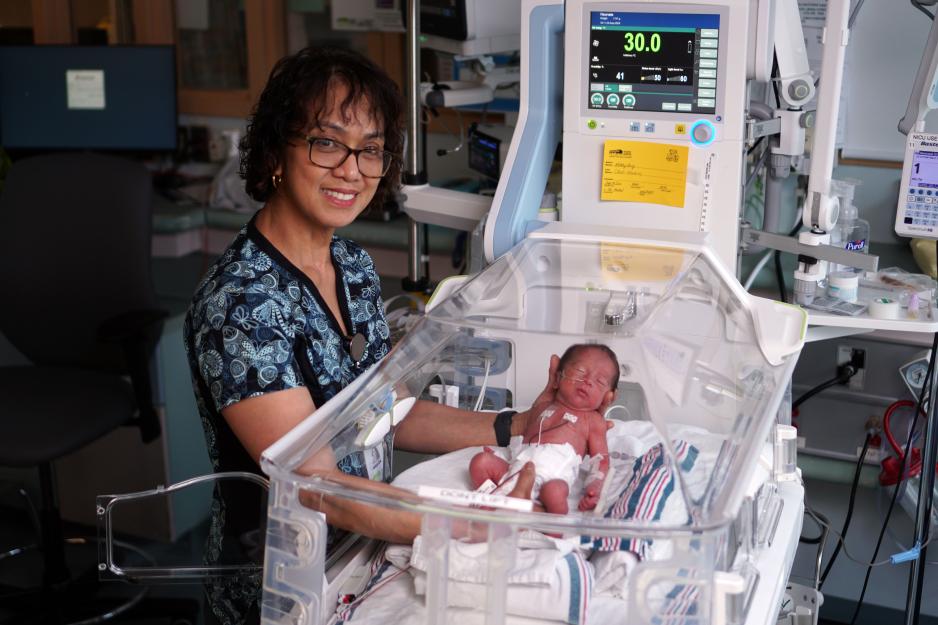 Imelda Macaraeg, Registered Nurse in MGH’s NICU, provides care for a baby.